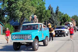 Robert Taylor rides in an old Bronco during the parade.