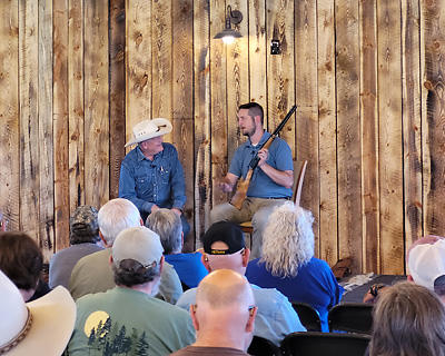 Craig Johnson talks with Danny Michael who is holding a firearm