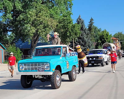 Robert Taylor rides in an old Bronco during the parade.